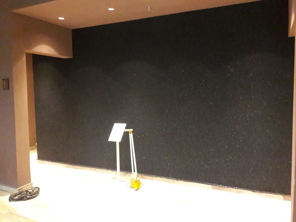 Dark cotton plaster wall in a hair salon