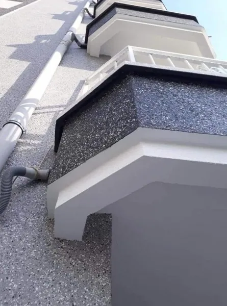 Grey, black and white speckled ceramic plaster on a balcony and façade